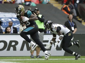 Jacksonville Jaguars tight end Marcedes Lewis, left, scores a touchdown past Baltimore Ravens strong safety Tony Jefferson during the second half of an NFL football game at Wembley Stadium in London, Sunday Sept. 24, 2017. (AP Photo/Matt Dunham)