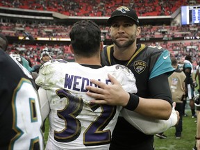 Jacksonville Jaguars quarterback Blake Bortles, right, greets Baltimore Ravens free safety Eric Weddle after an NFL football game at Wembley Stadium in London, Sunday Sept. 24, 2017. The Jaguars won 44-7. (AP Photo/Matt Dunham)