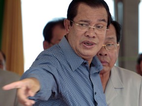 FILE - In this Aug. 23, 2017 file photo, Cambodia's Prime Minister Hun Sen gestures during his visit to Phnom Penh Special Economic Zone on the outskirts of Phnom Penh, Cambodia. Hun Sen said Thursday, Sept. 14, 2017 he will retaliate against a U.S. halt on the issuing of most visas to senior foreign ministry officials and their families by suspending missions by U.S. military-led teams searching for the remains of Americans missing in action from the Vietnam War. (AP Photo/Heng Sinith, File)