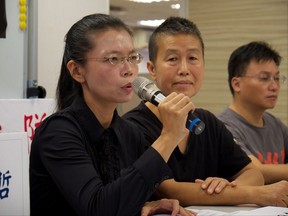 Lee Ching-yu, left, wife of Taiwanese activist Lee Ming-Che, holds a press briefing before her trip to China, Saturday, Sept. 9, 2017, in Taipei, Taiwan. Lee Ming-Che will be tried for subversion by a court in Yueyang city, in China's Hunan province on Sept. 11. (AP Photo/Johnson Lai)
