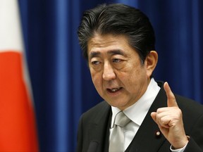 FILE - In this Aug. 3, 2017 file photo, Japan's Prime Minister Shinzo Abe speaks during a press conference after he reshuffled his Cabinet at the prime minister's official residence in Tokyo.  Japan is debating whether to develop limited pre-emptive strike capability and buy cruise missiles - ideas that were anathema in the pacifist country before the North Korea missile threat. With revisions to Japan's defense plans underway, ruling party hawks are accelerating the moves, and some defense experts say Japan should at least consider them. Abe called North Korea's missile firing on Aug. 29, 2017,  an "unprecedented, grave and serious threat." (AP Photo/Shizuo Kambayashi, File)