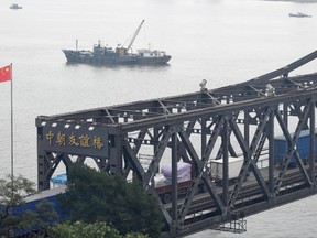 In this Sept. 5, 2017 photo, trucks transport goods to North Korea through the Friendship Bridge linking China and North Korea, as seen from Dandong in northeastern China's Liaoning Province. While condemning North Korea over its latest nuclear test, the leaders of Russia and South Korea seemed far apart on the issue of stepping up sanctions against the country. (Minoru Iwasaki/Kyodo News via AP)