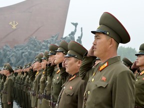 North Korean soldiers salute at Munsu Hill in Pyongyang, North Korea to mark the 69th anniversary of the country's founding Saturday, Sept. 9, 2017. (Kyodo News via AP)
