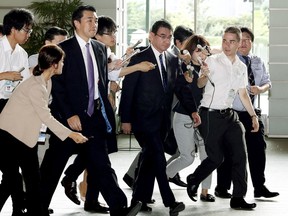Japanese Foreign Minister Taro Kono, center, arrives at prime minister's official residence in Tokyo Friday morning, Sept. 15, 2017 following a report of North Korean missile launch. South Korea's military said North Korea fired an unidentified missile Friday from its capital Pyongyang that flew over Japan before landing in the northern Pacific Ocean. (Saki Tsukada/Kyodo News via AP)