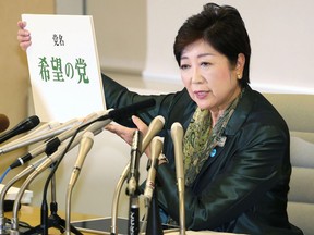 Tokyo Gov. Yuriko Koike holds the name of her Hope Party during a press conference at the Tokyo Metropolitan Government Office in Tokyo, Monday, Sept. 25, 2017.  Koike is launching a new political party to challenge Prime Minister Shinzo Abe's ruling party in national elections that are expected next month.  Koike said Monday she is heading the Hope Party and plans to send candidates to vie for some of the 475 seats in the lower house.  (Takuya Inaba/Kyodo News via AP)