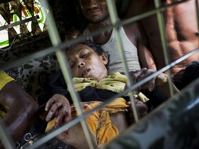 FILE - In this Sept. 4, 2017, file photo, an injured elderly woman and her relatives rush to a hospital on an autorickshaw, near the border town of Kutupalong, Bangladesh, after the Rohingya woman encountered a landmine that blew off the right leg while trying to cross into Bangladesh. Myanmar's military has been accused of planting land mines in the path of Rohingya Muslims fleeing violence in its western Rakhine state, with Amnesty International reporting two people wounded Sunday, Sept. 10, 2017. (AP Photo/Bernat Armangue, File)