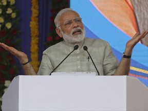 FILE - In this  June 30, 2017, file photo, Indian Prime Minister Narendra Modi speaks at an event a day before the implementation of the nationwide Goods and Services Tax in Ahmadabad, India. Modi came to power on a euphoric wave of promises to boost the economy. Three years later, India's economic prospects are looking decidedly more grim. India's economic expansion has slowed to its lowest level in three years. (AP Photo/Ajit Solanki, File)