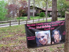 FILE - In this April 19, 2013 file photo, a poster with pictures of missing Tennessee nursing student Holly Bobo hangs on a fence in front of her house in Parsons, Tenn. On Monday, Sept. 11, 2017, Zachary Adams goes to trial for the murder, rape and kidnapping of Bobo, in a case that has gained national attention and shaken a small town to its core. (AP Photos/Adrian Sainz, File)