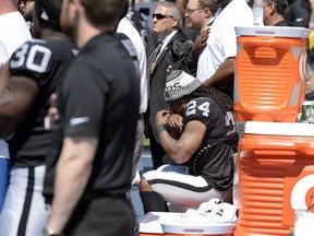 Oakland Raiders running back Marshawn Lynch (24) sits during the national anthem before an NFL football game between the Raiders and the Tennessee Titans Sunday, Sept. 10, 2017, in Nashville, Tenn. (AP Photo/Mark Zaleski)