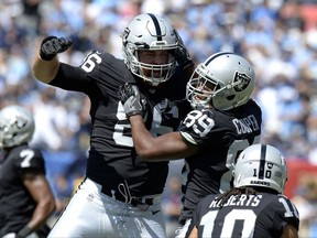 Oakland Raiders wide receiver Amari Cooper (89) celebrates with Lee Smith (86) after Cooper scored a touchdown on an 8-yard pass against the Tennessee Titans in the first half of an NFL football game Sunday, Sept. 10, 2017, in Nashville, Tenn. (AP Photo/Mark Zaleski)