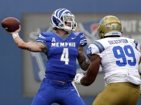 Memphis quarterback Riley Ferguson (4) passes as he is pressured by UCLA defensive lineman Matt Dickerson (99) in the first half of an NCAA college football game Saturday, Sept. 16, 2017, in Memphis, Tenn. (AP Photo/Mark Humphrey)