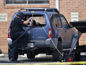 FILE - In this Sept. 24, 2017, file photo, police investigate the scene outside the Burnette Chapel Church of Christ after a deadly shooting at the church, in Antioch, Tenn. The shooting at a Tennessee church again demonstrated that deadly violence at U.S. houses of worship is not rare. (Andrew Nelles/The Tennessean via AP, File)