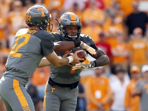 Tennessee running back John Kelly (4) takes the hand off from quarterback Quinten Dormady (12) during the first half of an NCAA college football game against Georgia, Saturday, Sept. 30, 2017, in Knoxville, Tenn. (AP Photo/Wade Payne)