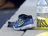 Shoes and a toy car lay near police tape after a toddler was pulled from a hot car in Toronto.