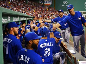 Toronto Blue Jays players celebrate a Kendrys Morales home run against the Boston Red Sox on Sept. 4.