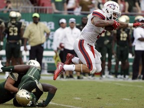Stony Brook wide receiver Donavin Washington (5) breaks a tackle by South Florida linebacker Jimmy Bayes (4) during the first quarter of an NCAA college football game Saturday, Sept. 2, 2017, in Tampa, Fla. (AP Photo/Chris O'Meara)