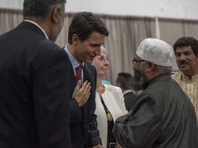 Prime Minster Justin Trudeau, left, shakes hands with Imam Sheikh Ilya Sidyot during Eid al-Adha at Prairieland Park in Saskatoon, Friday, September 1, 2017.