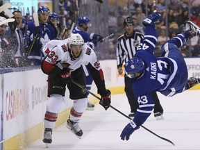 Ottawa Senators defenceman Fredrik Claesson (left) checks Toronto Maple Leafs forward Nazem Kadri on Sept. 19.