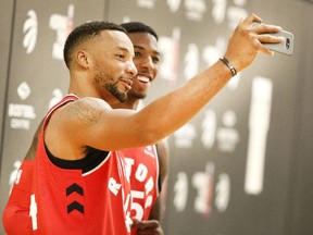 Norman Powell takes a photo of himself and Delon Wright during the Toronto Raptors' media day at the BioSteel Centre in Toronto, Ont. on Monday, Sept. 25, 2017.