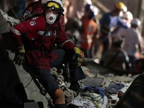 Personnel work in rescue operations in the rubble of a building felled by a 7.1 magnitude earthquake, in the Ciudad Jardin neighborhood of Mexico City, Thursday, Sept. 21, 2017. Thousands of professionals and volunteers are working frantically at dozens of wrecked buildings across the capital and nearby states looking for survivors of the powerful quake that hit Tuesday. (AP Photo/Eduardo Verdugo)