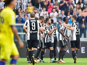 Juventus players celebrates after scoring a goal during the Italian Serie A Soccer match between Juventus and Chievo at the Allianz Stadium in Turin, Italy, Saturday, Sept. 9, 2017. (Alessandro Di Marco/ANSA via AP)