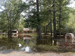 Homes west of River Road remain flooded as residents begin the task of gutting and trying to restore their homes. The community was cleared for entry as flood waters have receded to safer levels throughout the majority of the community, Wednesday, Sept. 6, 2017 in Bevil Oaks, Texas. (Kim Brent/The Beaumont Enterprise via AP)