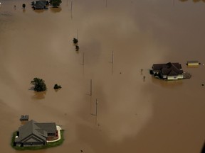 Homes are submerged by water from the flooded Brazos River in the aftermath of Hurricane Harvey Friday, Sept. 1, 2017, near Freeport, Tex.
