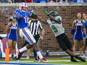 SMU wide receiver Courtland Sutton (16) catches a pass ahead of North Texas defensive back Nate Brooks (9) just before he falls to the end zone for a touchdown during the second quarter of an NCAA college football game, Saturday, Sept. 9, 2017 at SMU's Ford Stadium in Dallas. (Ashley Landis/The Dallas Morning News via AP)
