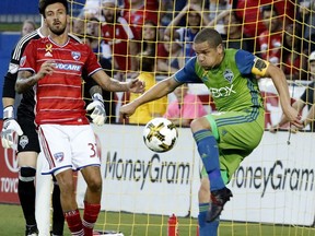 FC Dallas forward Maximiliano Urruti (37) watches as Seattle Sounders midfielder Osvaldo Alonso (6) defends a scoring opportunity during the first half of an MLS soccer match Saturday, Sept. 16, 2017, in Frisco, Texas. (Stewart F. House/The Dallas Morning News via AP)