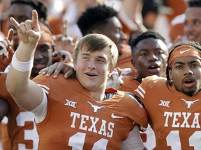 Texas quarterback Sam Ehlinger, left, defensive back P.J. Locke III, right, sing the school song following their win over San Jose State in an NCAA college football game, Saturday, Sept. 9, 2017, in Austin, Texas. Texas won 56-0. (AP Photo/Eric Gay)