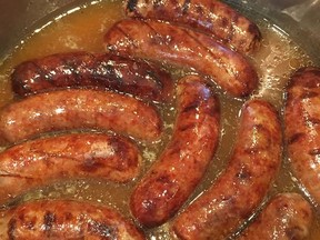 This Sept. 17, 2017 photo shows bratwurst sausages simmered in beer in Houston. This dish is from a recipe by Elizabeth Karmel. (Elizabeth Karmel via AP)