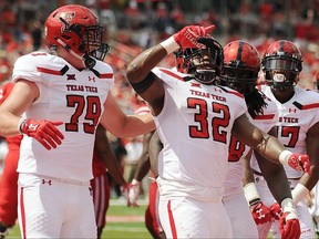 Texas Tech running back Desmond Nisby (32) celebrates his touchdown with Travis Bruffy (79) during the first half of an NCAA college football game against Houston, Saturday, Sept. 23, 2017, in Houston. (AP Photo/Eric Christian Smith)
