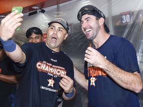Houston Astros' Justin Verlander, right, and Carlos Beltran celebrate the team's win over the Seattle Mariners and the clinching of the AL West crown in a baseball game, Sunday, Sept. 17, 2017, in Houston. (AP Photo/Eric Christian Smith)