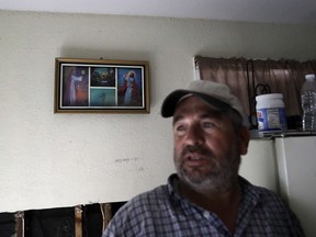 In this Sunday, Sept. 3, 2017, photo, religious images are almost all that still hang on the walls of Lino Saldana's home, as he talks about the floodwaters from a nearby bayou that swept through his home in Houston. Like many of his neighbors on flood-ravaged Minden Street, Saldana knows that if he doesn't work, he doesn't get paid. Harvey's epic 52 inches of rain didn't discriminate between rich and poor areas with its flooding, but in working-class neighborhoods where many live paycheck to paycheck, the cleanup and recovery could be an even tougher slog. (AP Photo/Gregory Bull)
