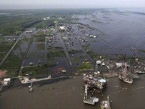 Flooding from Tropical Storm Harvey surrounds buildings in Sabine Pass, Texas, next to the Gulf of Mexico, Thursday, Aug. 31, 2017.