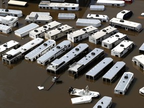 A line of recreational vehicles sit submerged by floodwaters of Tropical Storm Harvey on Friday, Sept. 1, 2017, near Vidor, Texas. (Brett Coomer/Houston Chronicle via AP)