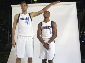 Dallas Mavericks forward Dirk Nowitzki (41) of Germany jokingly poses for a photo with new teammate guard Dennis Smith Jr. (1) during an NBA basketball team media day in Dallas, Monday, Sept. 25, 2017. (AP Photo/LM Otero)