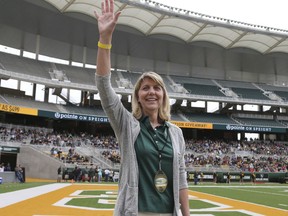 FILE - In this April 22, 2017, file photo, Baylor's new president Linda A. Livingstone waves to the fans as she is introduced during the first half of the NCAA college football team's Green and Gold spring game, in Waco, Texas. Baylor University settled a federal lawsuit filed by a former student who said she was gang raped by two football players and alleged the program at the nation's largest Baptist school fostered a "culture of violence." Details of the settlement announced Tuesday were not disclosed. The woman's attorney, John Clune, said the deal was reached within the last week. Clune credited new Baylor President Linda Livingstone with pushing Baylor to address the lawsuits and how it can improve its response to sexual assault in the future.  (Jerry Larson/Waco Tribune Herald via AP, File)