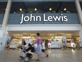 Pedestrians pass outside a John Lewis Plc department store in Milton Keynes, U.K., on Monday, July 21, 2014