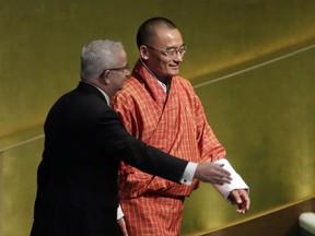Prime Minister Tshering Tobgay of Bhutan is escorted to the podium to address the United Nations General Assembly, at U.N. headquarters, Friday, Sept. 22, 2017. (AP Photo/Richard Drew)