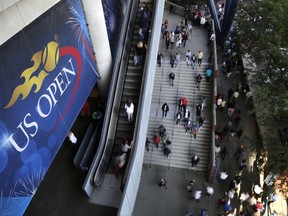 Tennis fans move in and out of Arthur Ashe Stadium during the fourth round of the U.S. Open tennis tournament, Sunday, Sept. 3, 2017, in New York. (AP Photo/Frank Franklin II)