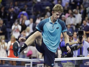 Kevin Anderson, of South Africa, steps over the net after beating Pablo Carreno Busta, of Spain, in the semifinals of the U.S. Open tennis tournament, Friday, Sept. 8, 2017, in New York. (AP Photo/Julio Cortez)