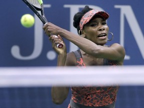 Venus Williams, of the United States, returns a shot from Carla Suarez-Navarro, of Spain, during the fourth round of the U.S. Open tennis tournament, Sunday, Sept. 3, 2017, in New York. (AP Photo/Frank Franklin II)
