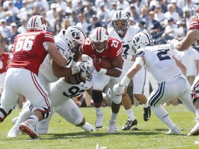 Wisconsin running back Jonathan Taylor (23) breaks a tackle in the first half during an NCAA college football game against BYU, Saturday, Sept. 16, 2017, in Provo, Utah. (AP Photo/Kim Raff)