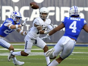 BYU defensive back Zayne Anderson (23) breaks up a pass intended for Utah State wide receiver Jordan Nathan (16) as linebacker Fred Warner (4) helps defend during an NCAA college football game, Friday, Sept. 29, 2017, in Logan, Utah. (Eli Lucero/Herald Journal via AP)