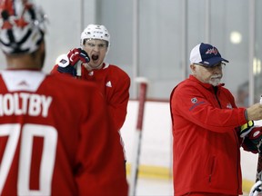 Washington Capitals defenseman Dmitry Orlov, center, yawns as head coach Barry Trotz, right, explains the next drill during practice at their NHL hockey practice facility, Friday, Sept. 15, 2017 in Arlington, Va. (AP Photo/Alex Brandon)