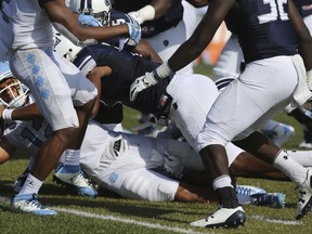 UNC's Chazz Surratt (12) scores a touchdown during the first half of an NCAA college football game Old Dominion, Saturday, Sept. 16, 2017 in Norfolk, Va. (AP Photo/Jason Hirschfeld)
