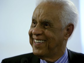 FILE - In this May 8, 2014 file photo, former Virginia Gov. Douglas Wilder listens to a question from the media during a news conference at the State Capitol in Richmond. The nation's first elected black governor says improving education is more important than spending tax money to remove Confederate monuments.  Wilder said during an interview on C-SPAN Thursday, Sept. 29, 2017,  his election in 1989 showed how Virginia had changed. He said the violent white nationalist rally in Charlottesville in August does not represent the city or the state.  (Bob Brown/Richmond Times-Dispatch via AP)