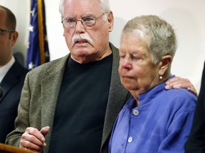 John Lyon hugs his wife, Mary, right, after a plea by Lloyd Lee Welch Jr., for the killings of their daughters Sheila and Katherine Lyon in 1975, in Bedford County Circuit Court in Bedford, Va., Tuesday, Sept. 12, 2017. Welch plead guilty to two first degree murder charges and was sentenced to two consecutive 48 year terms. (AP Photo/Steve Helber)