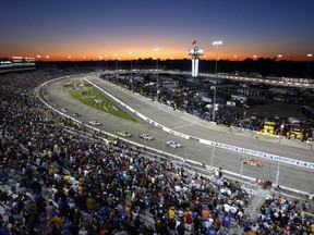 The sun sets behind Richmond International Raceway during the NASCAR Cup Series auto race in Richmond, Va., Saturday, Sept. 9, 2017. (AP Photo/Steve Helber)